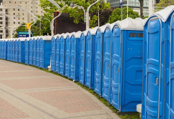 a line of portable restrooms at a sporting event, providing athletes and spectators with clean and accessible facilities in Babson Park, MA